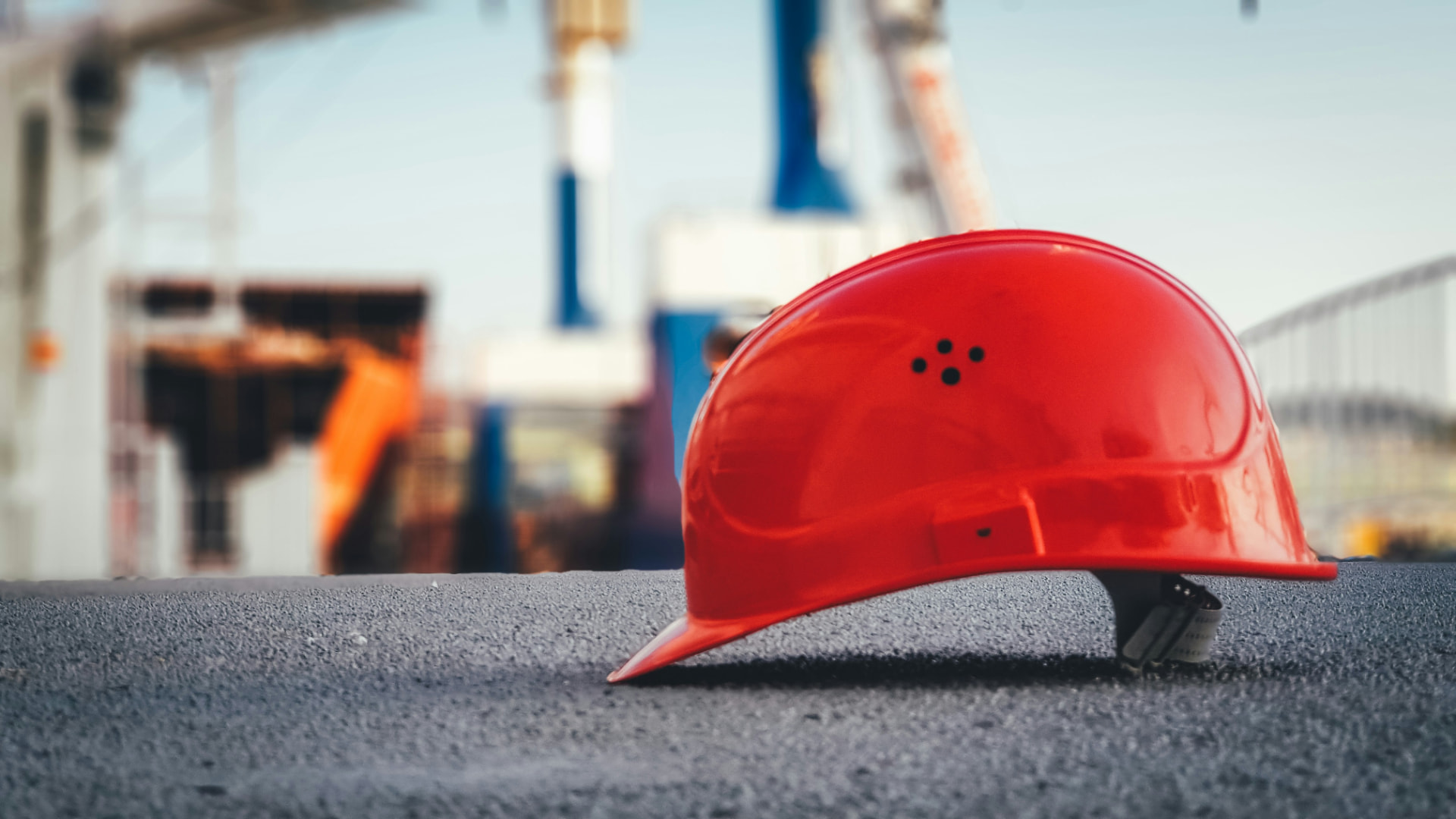 Helmet on a Gulf construction site with cranes behind